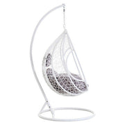 Front view of the white rattan effect hanging chair on a plain background