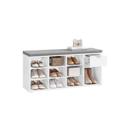 White shoe storage bench with grey padded seat, filled with shoes across nine cubbies and a boot space
