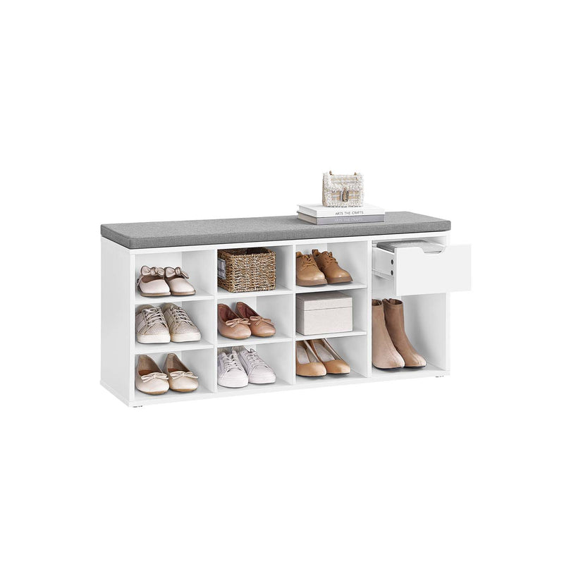 White shoe storage bench with grey padded seat, filled with shoes across nine cubbies and a boot space