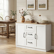 White sideboard angled in a dining area with a vase, plates and a basket on top