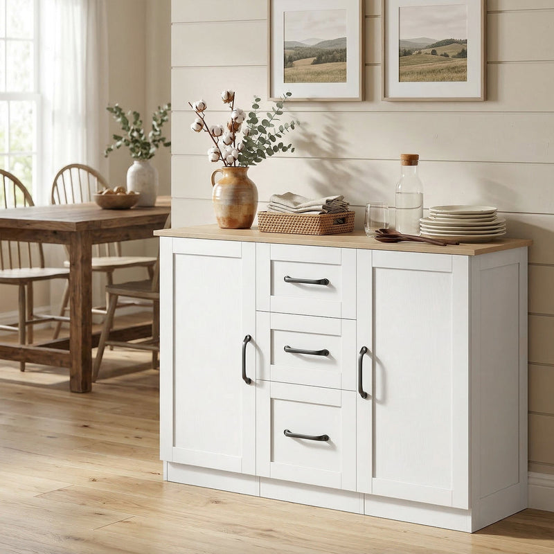 White sideboard angled in a dining area with a vase, plates and a basket on top