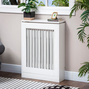 White radiator cover in a living room with a plant and books on the top shelf
