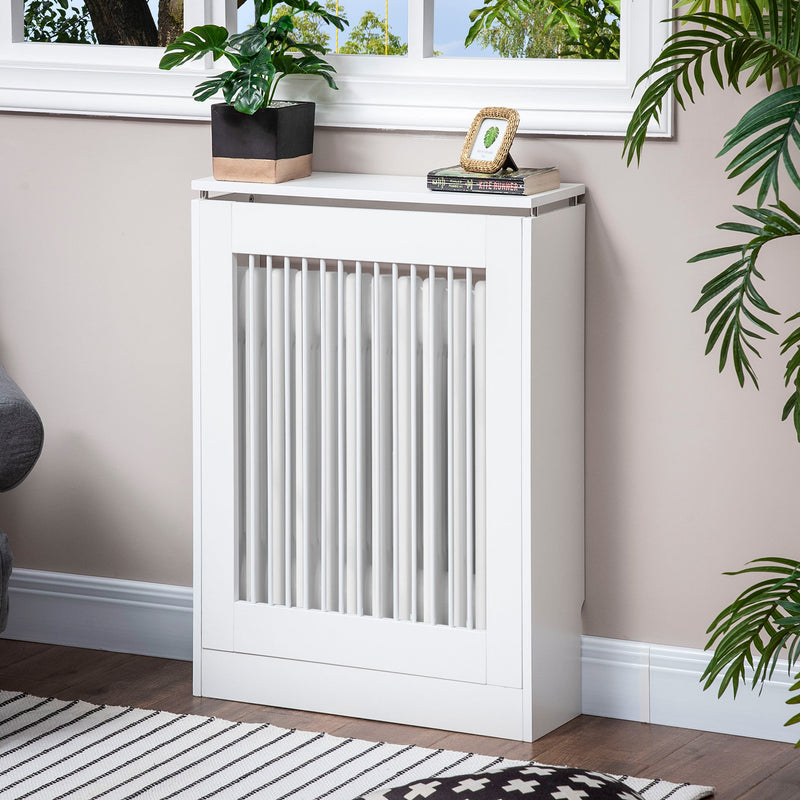 White radiator cover in a living room with a plant and books on the top shelf
