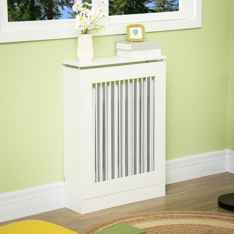 White radiator cover below a window with flowers and a photo frame on top