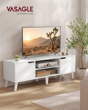 White TV stand in a living room beside a plant with a TV, amplifier and baskets on the shelves