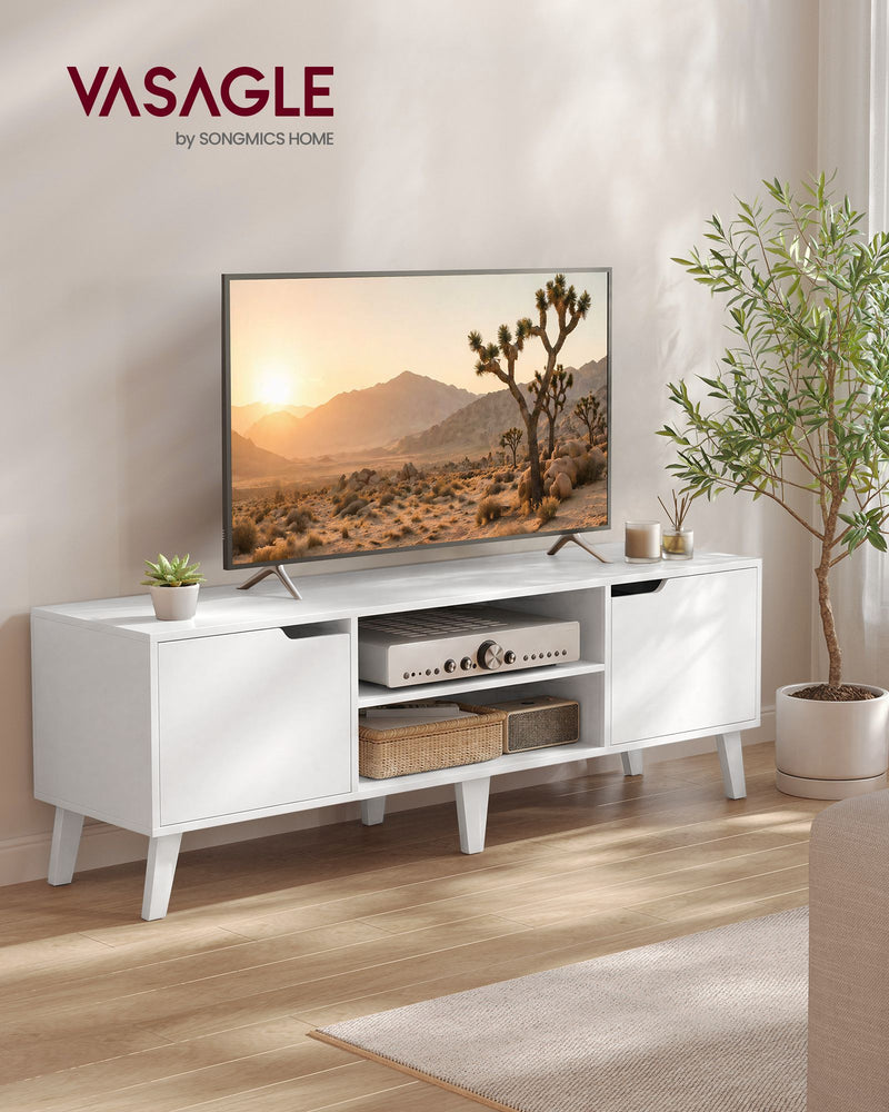 White TV stand in a living room beside a plant with a TV, amplifier and baskets on the shelves
