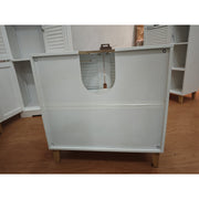 Rear of the white cabinet showing the U-shaped pipe cut-out