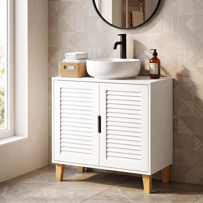 White cabinet beneath a round bowl basin with a black tap and a round mirror