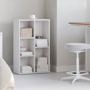 White wooden kids bookcase styled with books and decor in a bedroom