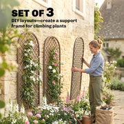 Woman positioning one of the set of 3 trellis panels against a stone wall