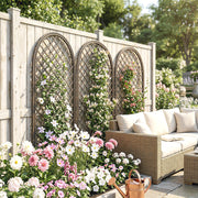 Trellis panels mounted on a wooden garden fence beside a rattan sofa seating area