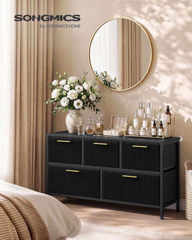 Songmics by Songmics Home branded lifestyle shot of the black corduroy chest with a round mirror and vase