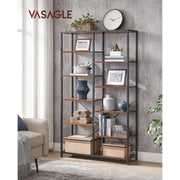 Bookcase in a living room holding vases, books and framed prints by a sofa