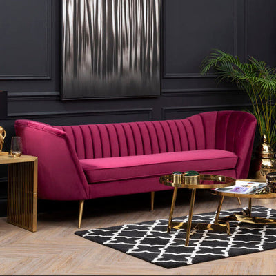 Wine velvet 3 seater sofa with gold legs styled in a living room