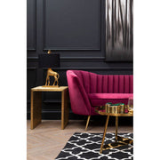 Wine velvet sofa styled in a furnished living room setting
