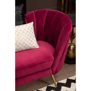 Wine velvet sofa styled with cushions in a lounge setting