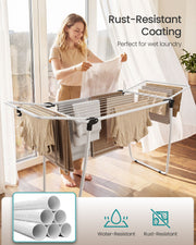 Woman hanging wet laundry on the airer beside a bright window with rust-resistant coating callout