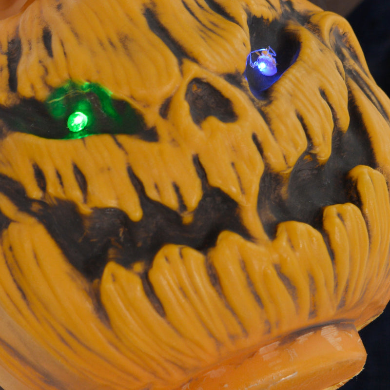 Close-up of the light-up carved pumpkin held by the Homcom witch with broomstick animatronic