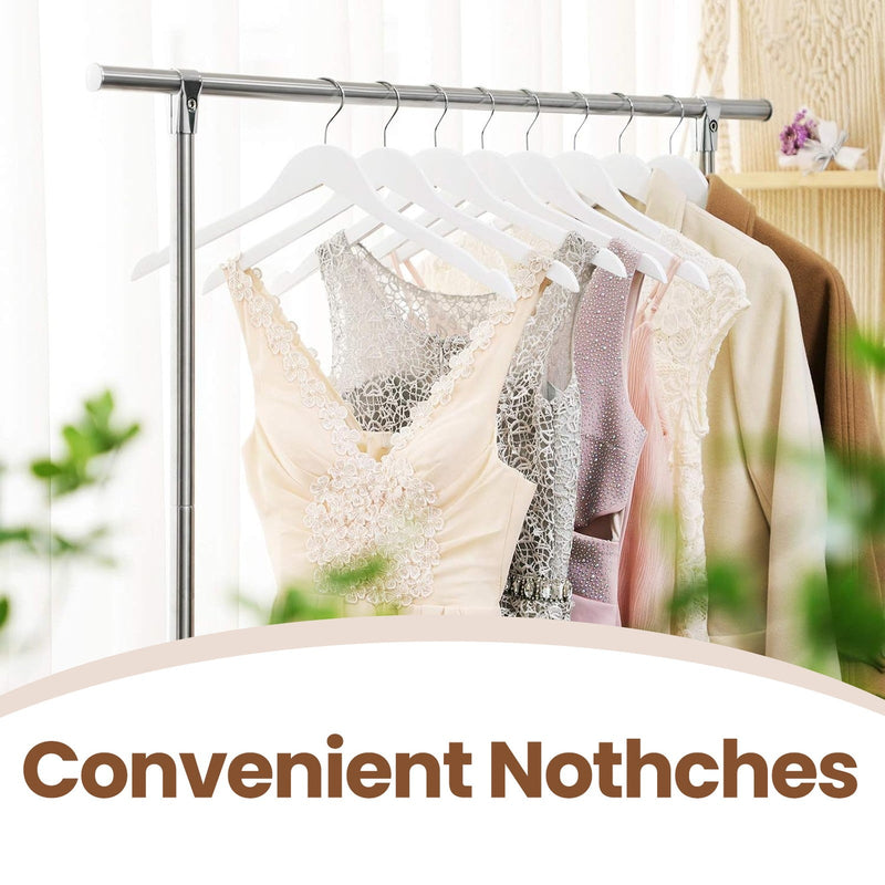 White wood hangers holding lace and formal dresses close up