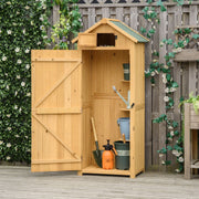 Natural wood sentry box shed open in a garden with a watering can and tools inside