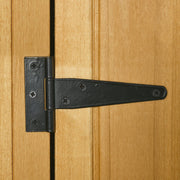 Close-up of the black T-hinge on the natural wood shed door