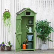 Green sentry box shed open against a white fence with pots and tools inside