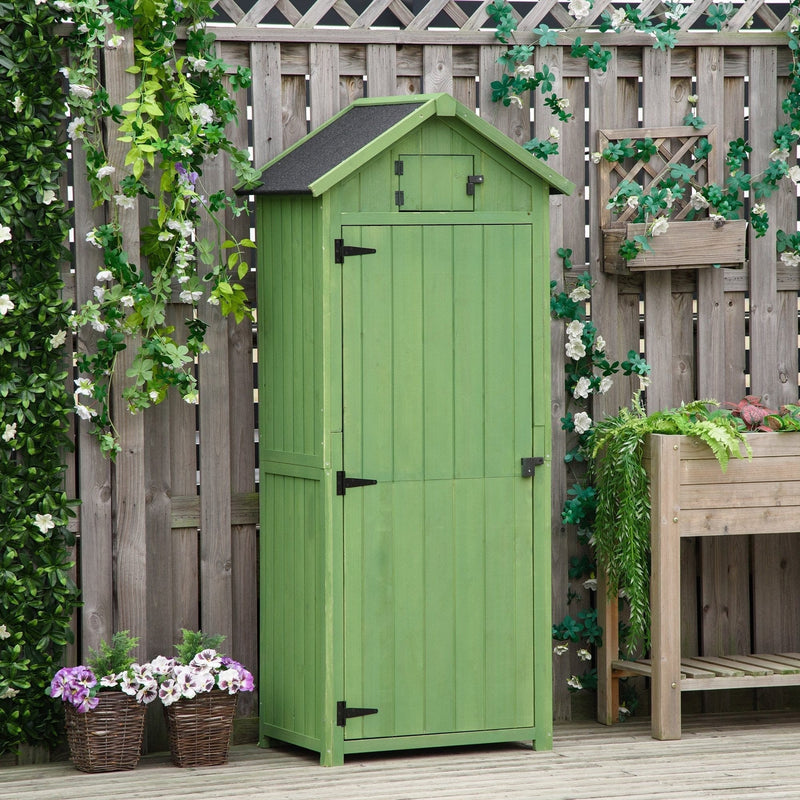 Green sentry box shed closed beside a wooden fence with flower baskets on decking