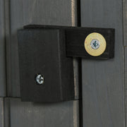 Close-up of the black wooden turn latch on the grey shed door