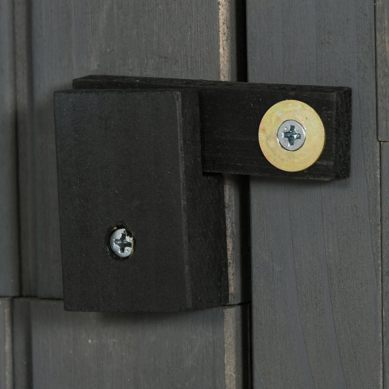 Close-up of the black wooden turn latch on the grey shed door