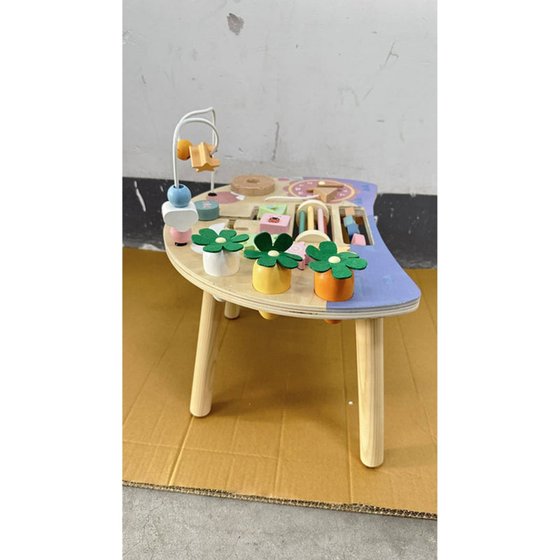 Side view of the activity table showing the blue half-round top and pine legs