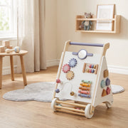 Baby walker standing on a rug in a nursery corner