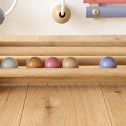 Close-up of wooden beads on the walker's rolling bar