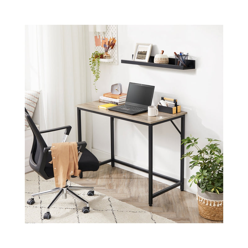 Wooden computer desk with storage shelf by Vasagle, styled in a home office setting