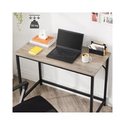 Wooden computer desk with storage shelf by Vasagle, side angle view