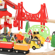 Close-up of the train wagons and construction vehicles beneath the red bridge