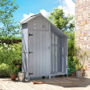 Grey wooden garden shed standing on a decked patio beside a stone wall