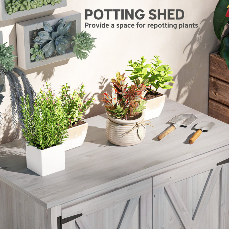 Potting shed panel showing plants and hand trowels laid out on the flat grey top