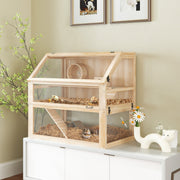 Natural wood hamster cage displayed on a white cabinet with flowers