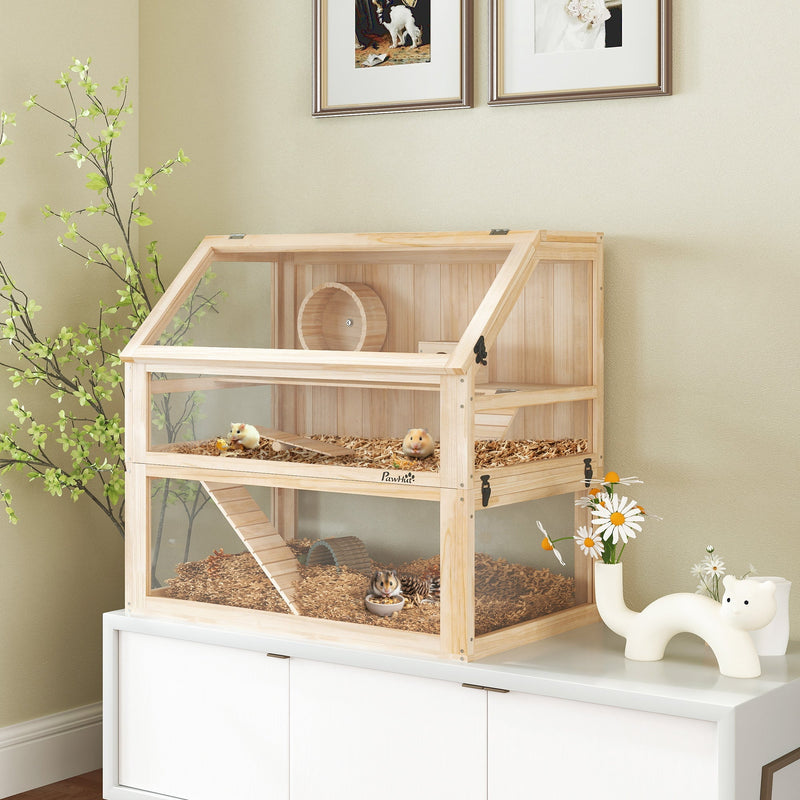 Natural wood hamster cage displayed on a white cabinet with flowers