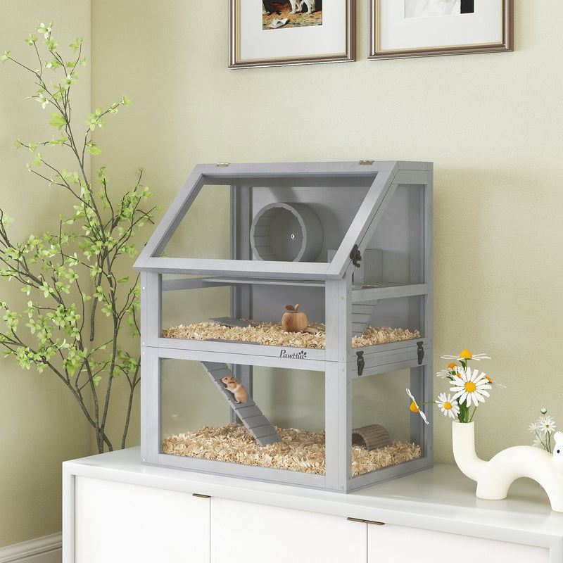 Light grey hamster cage displayed on a white cabinet with flowers