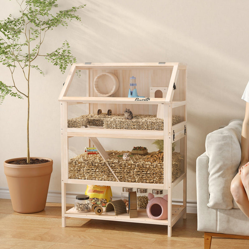 Natural wood hamster cage displayed on a wooden cabinet at home