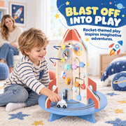 Boy pushing the rover around the rocket base beside a blast off into play banner