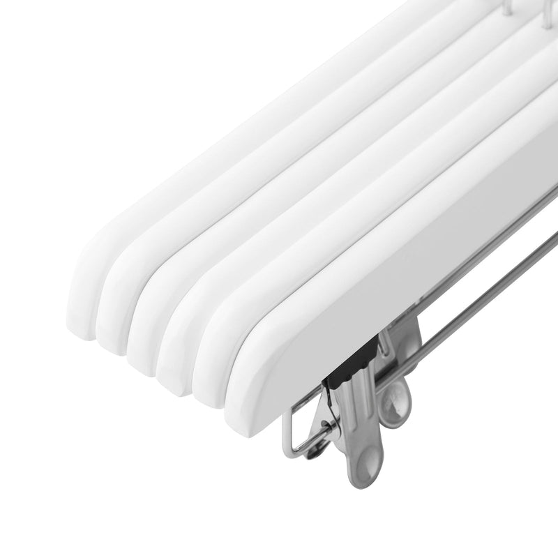 Close-up of the stacked bars of several white wooden hangers