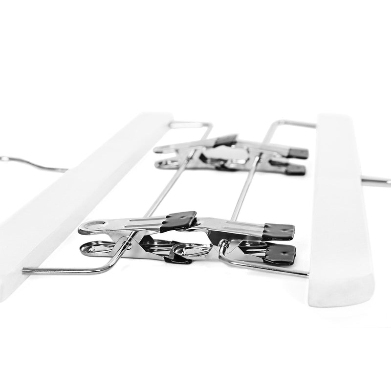 Angled view of the two chrome clips fitted along the bar of a white hanger