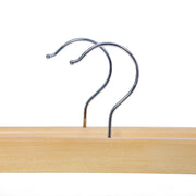 Close-up of the swivel chrome hooks on two natural wooden hangers