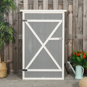 Grey wooden garden shed standing closed against a rustic timber fence
