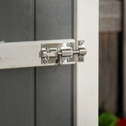 Close-up of the metal bolt latch on the grey shed door