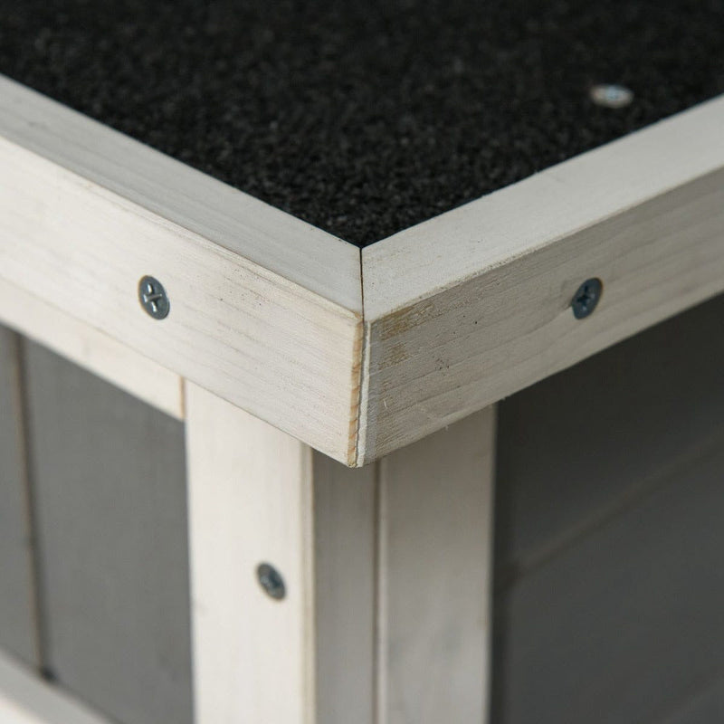 Close-up of the roof corner where the asphalt felt meets the white timber trim