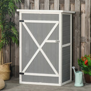 Grey wooden garden shed beside a fence with a watering can and plants