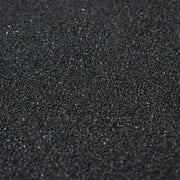 Close-up of the dark asphalt granules on the shed roof covering